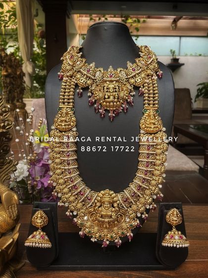 A majestic and heavy bridal set in an antique gold finish. The intricate details on the choker and the long haram are a testament to traditional craftsmanship.