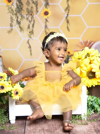 A joyful smile from another toddler enjoying the bright and sunny sunflower theme.