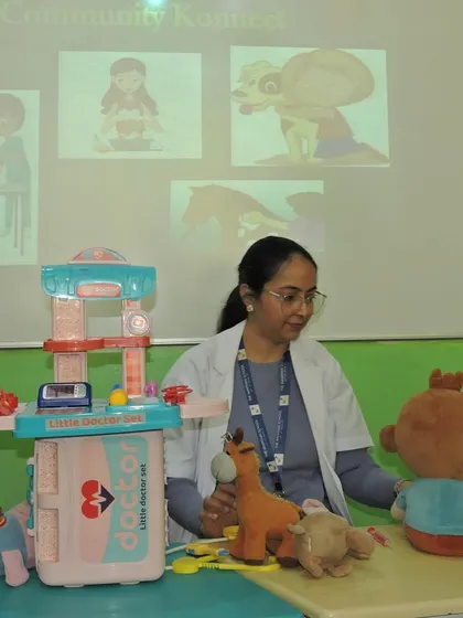 A teacher uses a toy doctor set and stuffed animals to teach about veterinary care. This role-playing activity helps children develop a sense of empathy and a duty to care for animals.
