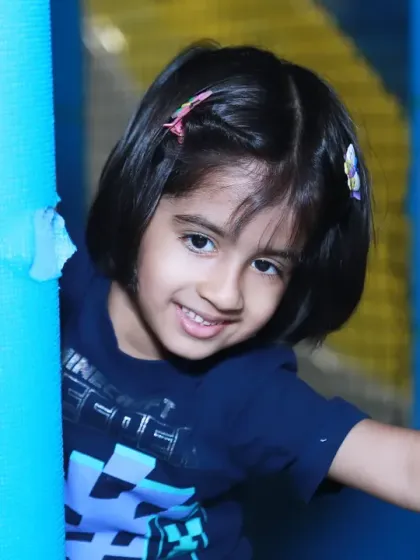A cute portrait of a girl peeking out from a play structure. I'm always looking for these little moments of playful hide-and-seek during events.