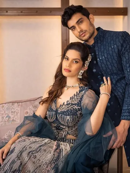 This is what we call a power couple look. The deep blue tones and detailed patterns create a sophisticated and cohesive style, perfect for making a grand entrance.