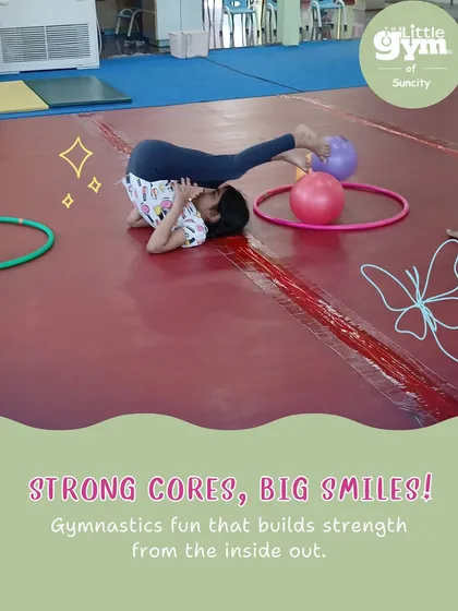 Strong cores, big smiles. This student practices a plow pose, a gymnastics drill that builds core strength and spinal flexibility, essential for more advanced moves.