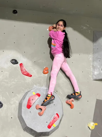 A huge smile mid-climb. My goal is to make climbing fun and accessible, and seeing happy faces like this on the wall is what it's all about.