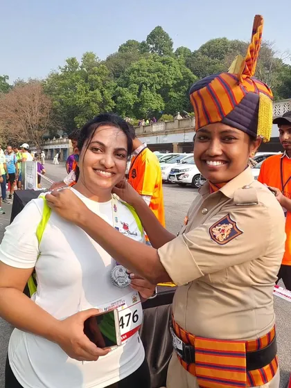 A special moment as a police officer awards a finisher medal to our team member at the Karnataka State Police Golden Jubilee Run.