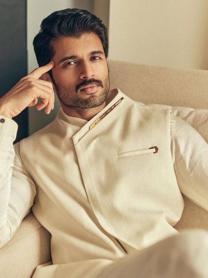 A close-up that captures the refined details and serene mood of Vijay's ivory ensemble.