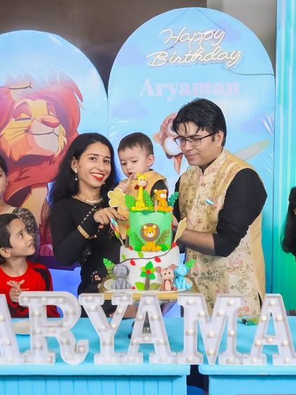 A charming 'Woodland' themed birthday party, with rustic decor, forest animal cutouts, and natural elements, creating a cozy and enchanting setting.