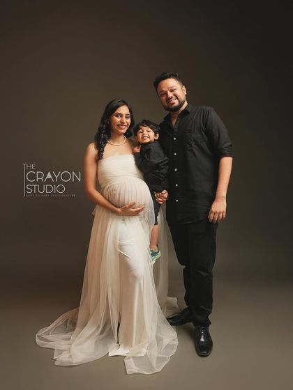 A beautiful portrait of the complete family, soon to be four. Everyone is smiling, creating a perfect, happy memory before the new baby arrives.