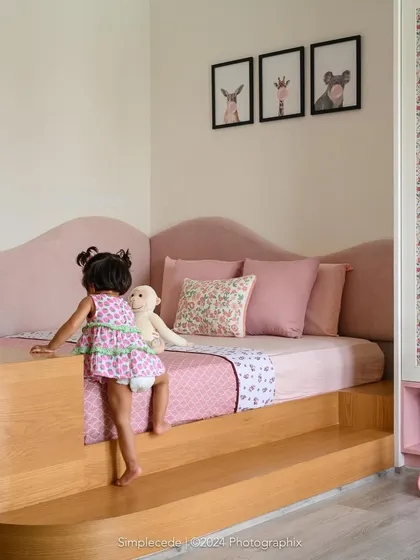 For the youngest member of the 'Cover me in Sunshine' family, we designed this blush-toned bedroom with a custom platform bed. The design is safe, accessible for a toddler, and filled with whimsical charm, proving that practical can also be beautiful.