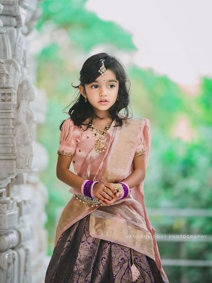 A stunning portrait of the young girl in her festive attire. Her thoughtful gaze and the beautiful details of her jewelry and dress are highlighted in this shot.