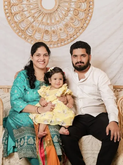 This family portrait showcases how our boho setting complements traditional Indian attire beautifully. The vibrant colors of their outfits pop against the neutral, textured background.