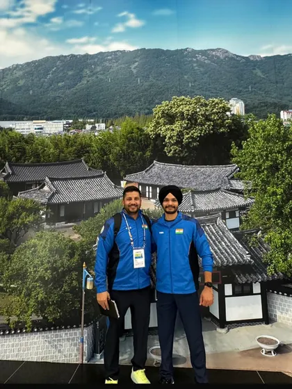 Posing with my student Sarabjot Singh during an international tour. Building a strong coach-athlete relationship is crucial for success at the highest level.