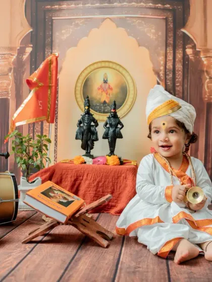A happy, smiling Varkari seated on the floor. This image radiates pure joy and innocence.