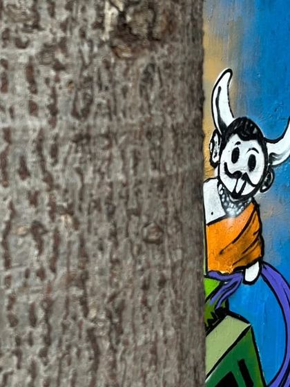 A fun shot of one of the characters from my Stylebound mural peeking out from behind a tree. It shows how street art can interact with the natural environment around it.