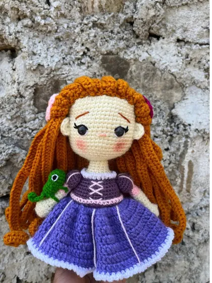 A still image of the handmade Rapunzel doll, holding her friend Pascal. I take care to capture the sweet expression on her face.