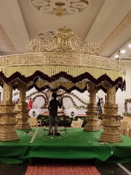This image shows a large, traditional wedding mandap during the setup phase. You can see the scale and detailed structure that goes into building these ornate centerpieces for the main wedding ceremony.
