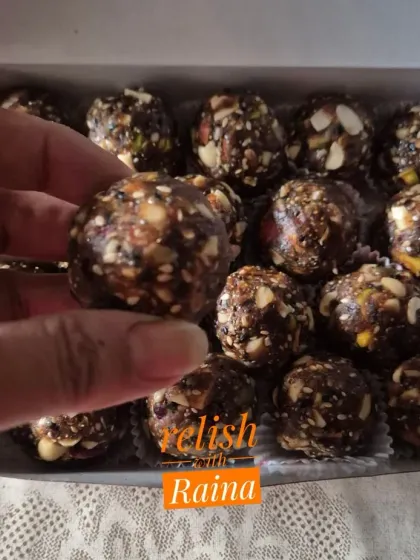 Holding up a Biotin Laddoo to show its dense, nutrient-packed texture.