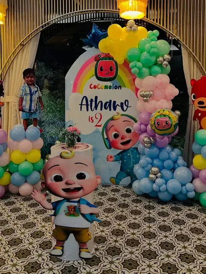 Another angle of the Cocomelon party, showing the custom cake stand and how the different elements come together for a great photo background.