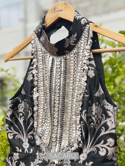A full view of the black and silver brocade halter top, showcasing its intricate embroidery and modern cut.