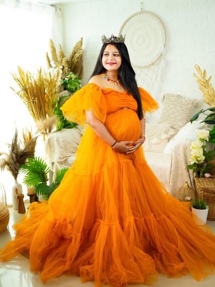 A princess in orange. This beautiful tulle gown brings a vibrant and cheerful energy to the portrait, taken in our bright and airy boho studio.