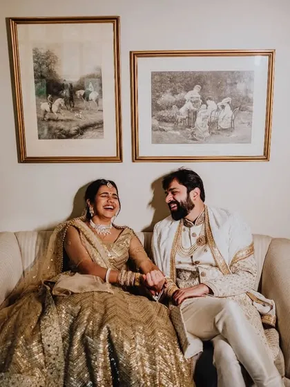 A candid moment of laughter on a vintage sofa. These relaxed portraits are often the most cherished.