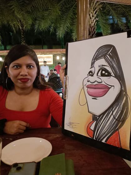 A guest in a striking red top with a caricature to match.