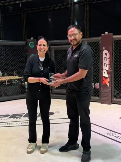 Our coach presenting an award at an MFN event, highlighting our integral role in the professional MMA circuit.