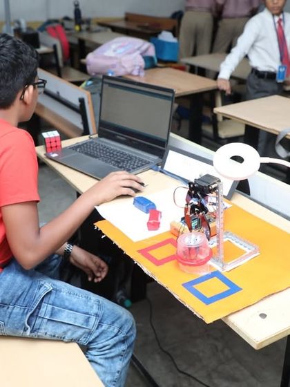 A student works independently at his desk, programming his robot. Our classroom setup provides each child with the space and tools they need to focus and bring their unique ideas to life.