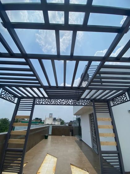 A modern pergola design featuring a roof with a geometric pattern and CNC laser-cut side panels for a decorative touch.