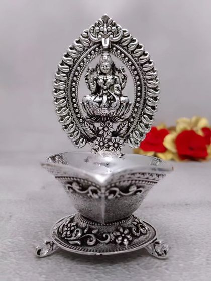 This antique German silver Lakshmi diya includes a stand for incense sticks (vathi). It's a thoughtful design that combines two pooja essentials in one beautiful piece.