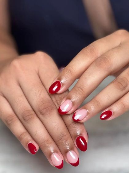 The full view of the red-on-red French manicure combination. It's a creative way to play with color and a classic design.