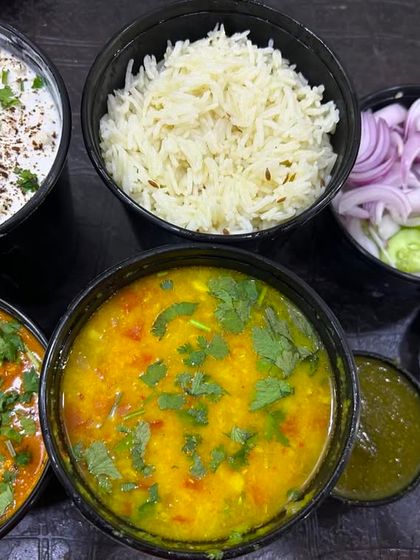 A complete meal package with individual containers for each dish. This ensures the flavors don't mix and the food stays fresh.