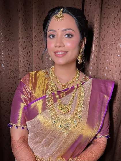 A classic portrait pose, showcasing the beautiful balance between the traditional attire and the modern, soft makeup.