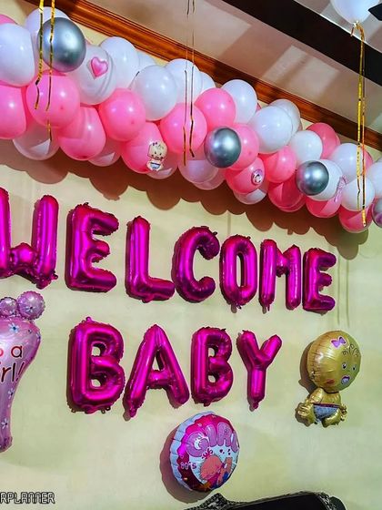 A close-up of the "Welcome Baby" decor, featuring pink foil letters and various baby-themed foil balloons. These elements are perfect for creating a festive and clear message of celebration.
