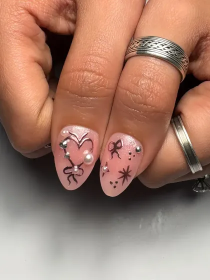 A focused look at the heart and bow details on these short almond nails. Even on a smaller canvas, we can pack in tons of cute, romantic art.
