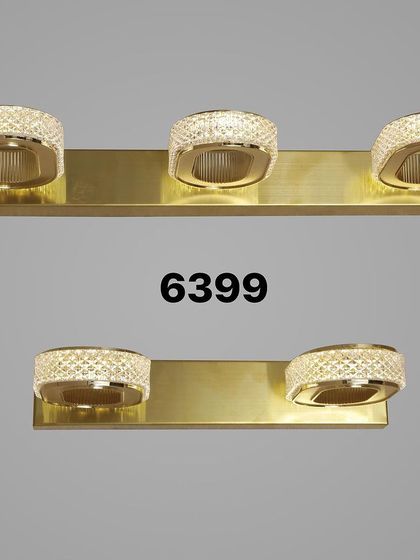 A modern vanity light with three adjustable, crystal-dusted heads on a brass bar. Perfect for providing bright, even light in a bathroom.