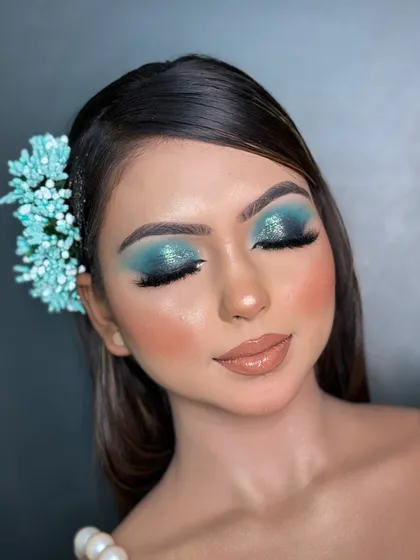 A full view of the eye makeup with eyes closed. This shows the clean application of the liner and lashes, which are essential components for finishing any professional eye makeup look.
