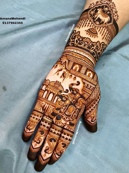 A full view of a complex design in progress. The intricate details of the cow, elephant, and palace motifs are starting to take shape.