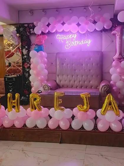 A close-up of the first birthday stage with the name 'SHREJA' spelled out.