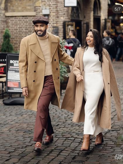 Walking down a cobblestone street in London. Their coordinated coats and vintage-inspired styling create a look that is both timeless and effortlessly cool.