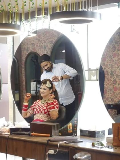 A behind-the-scenes shot of the bride getting her hair done at the salon. This photo captures the final stages of her transformation and the anticipation of the moments to come.