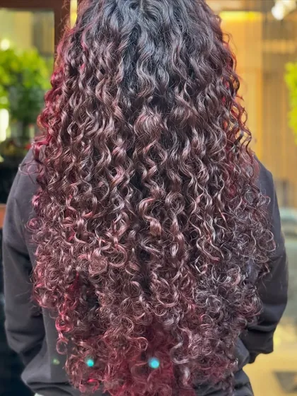 On longer hair, a red balayage creates a beautiful, flowing cascade of color.