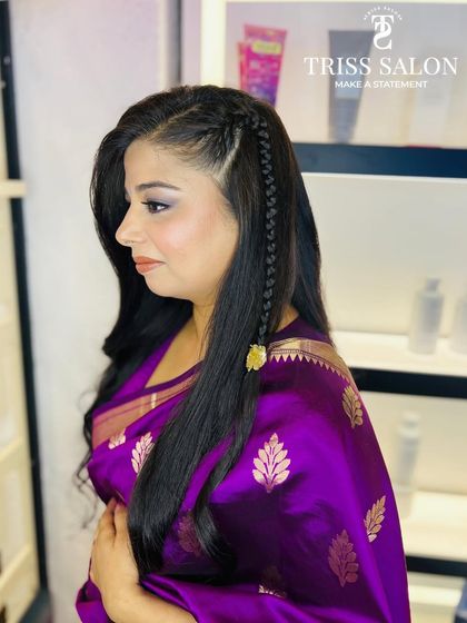 A side view showing the simple yet elegant braided hairstyle I created to go with her soft makeup look.