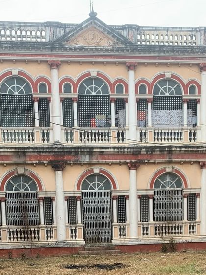 The facade of an Art Deco palatial house, showing the grand scale and repetitive arched windows that define its unique architectural style.