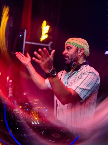 A motion-blur shot capturing my energy and movement while mixing at 'Mondaze'.