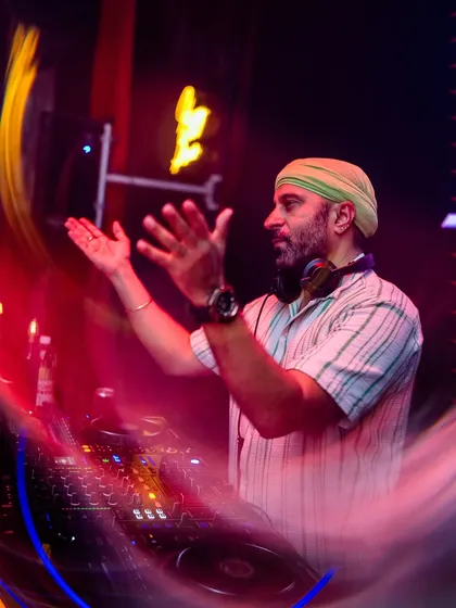 A motion-blur shot capturing my energy and movement while mixing at 'Mondaze'.
