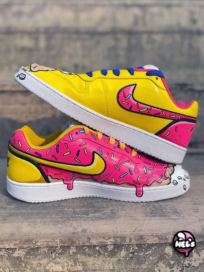 A stacked shot of the Homer and donut themed Nike sneakers, showing how the two complementary designs create one awesome pair.