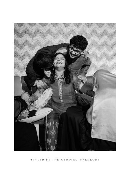 A black and white shot capturing the fun and chaos of a mehendi ceremony. These are the moments that become cherished memories, and we style our clients to be comfortable enough to enjoy them fully.