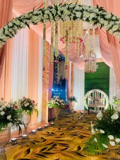 We don't just bring the food, we bring the whole celebration. Look at this beautiful floral archway we created for a wedding reception. We can handle all the decoration to make your event look grand.