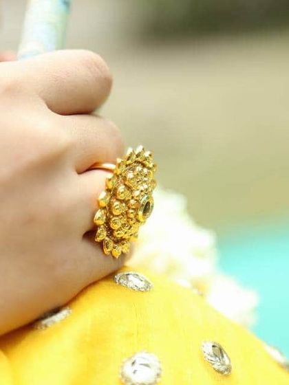 A traditional gold-plated adjustable wedding ring, perfect for a bride.