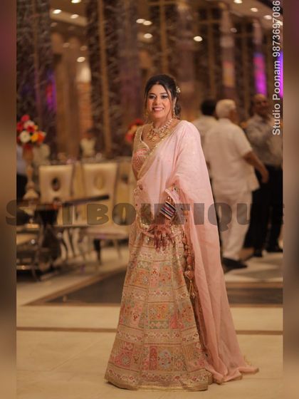 A full-length shot of this elegant pastel lehenga, showing how the soft colors and detailed craftsmanship create a sophisticated look.